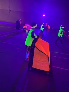 UV-Football Children in neon kit playing football under UV lighting at a Nexgen UV party
