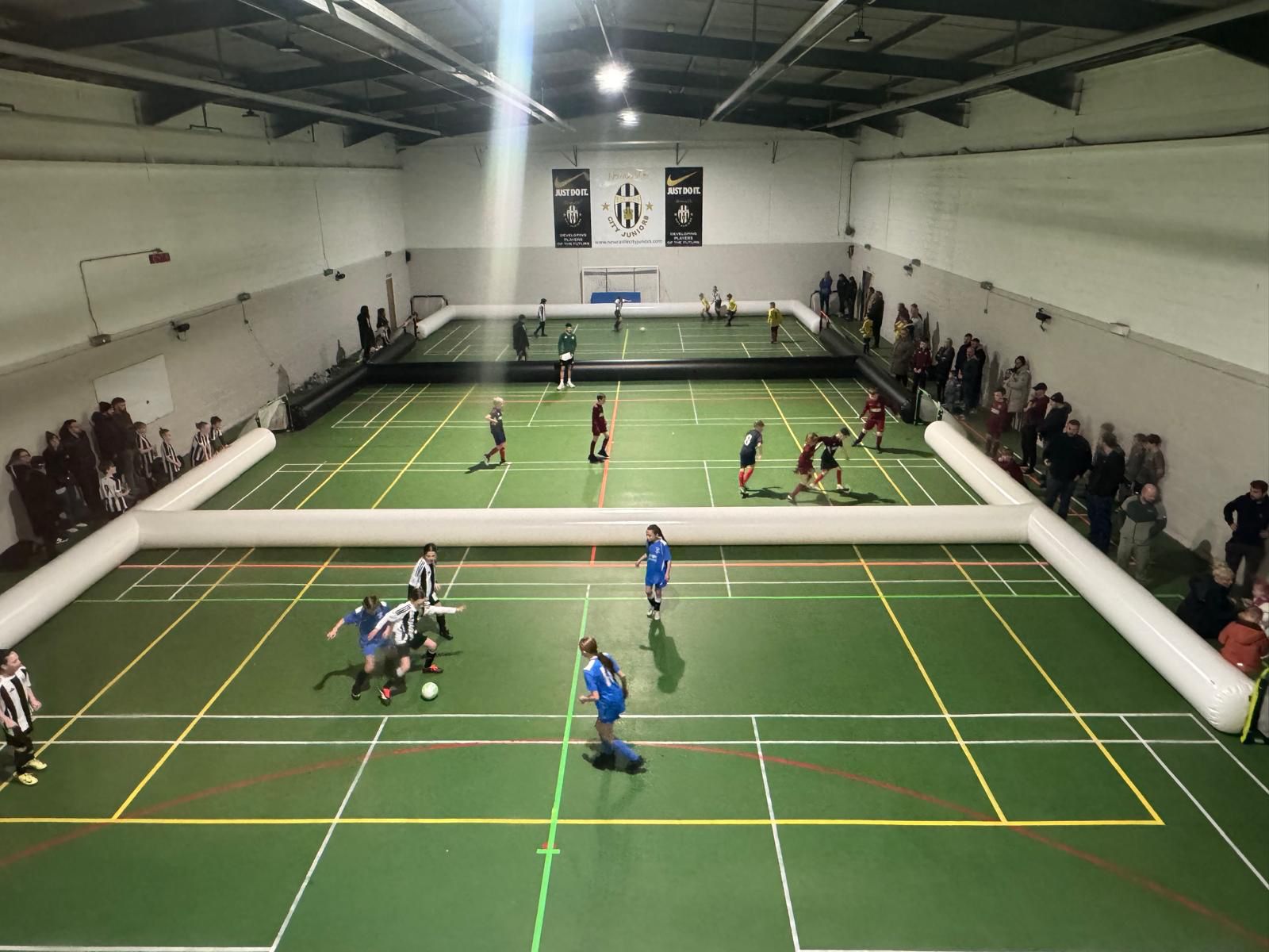 3v3 games in progress across an indoor sports hall